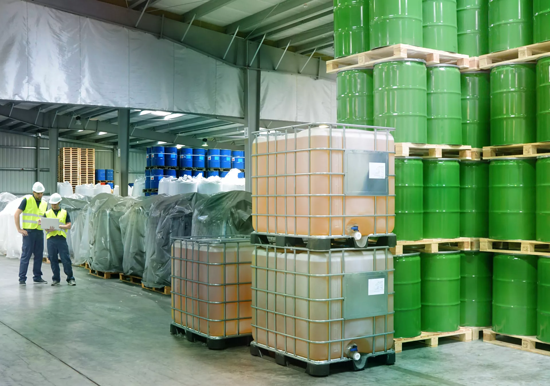 group of workers in the logistics industry work in a warehouse with chemicals