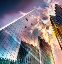 Bottom view of modern skyscrapers in business district in beautiful evening light at sunset