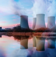 Nuclear power plant after sunset. Dusk landscape with big chimneys.