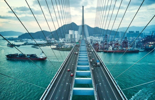 Bridge leading into Hong Kong with container ships