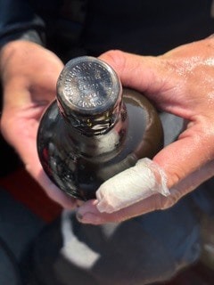 Divers recover a bottle of Guinness from a 162-year-old shipwreck