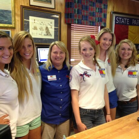 State Park Marina staff members pose behind the checkout counter in the Boathouse store.