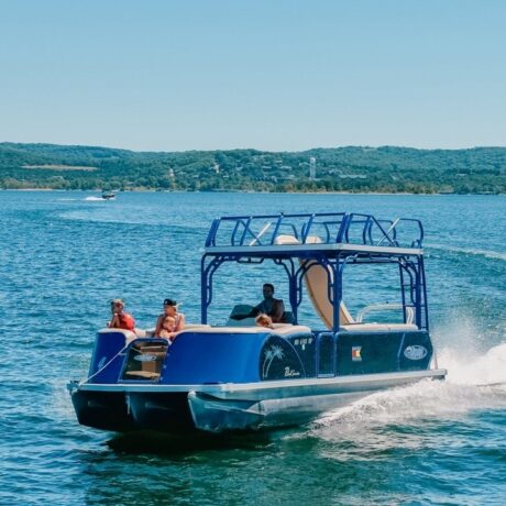 Guests cruise in State Park Marina’s blue Aloha pontoon as it turns on Table Rock Lake.