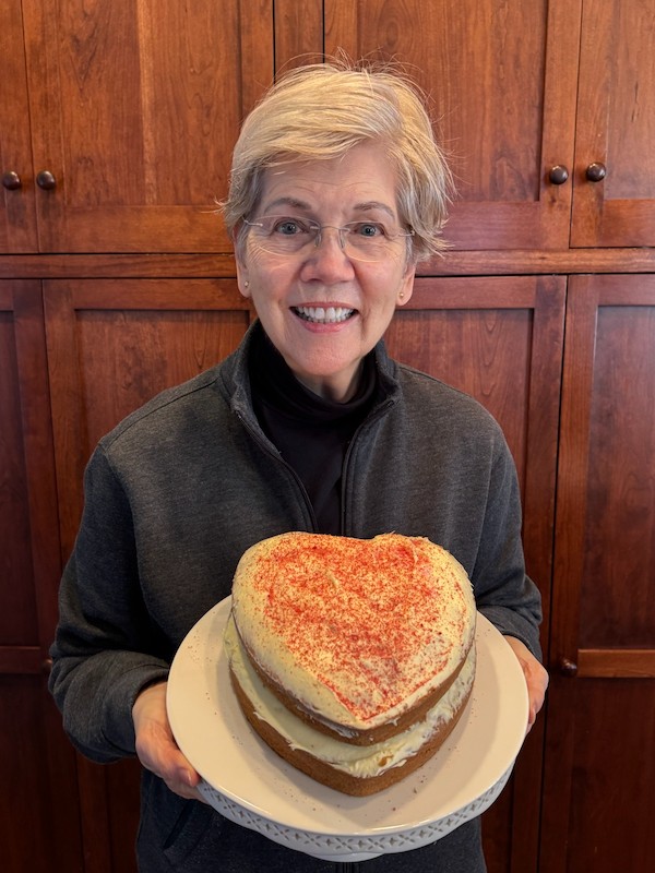 Elizabeth Warren holding a cake