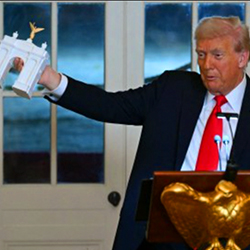 Trump holding a model Arc de Trump