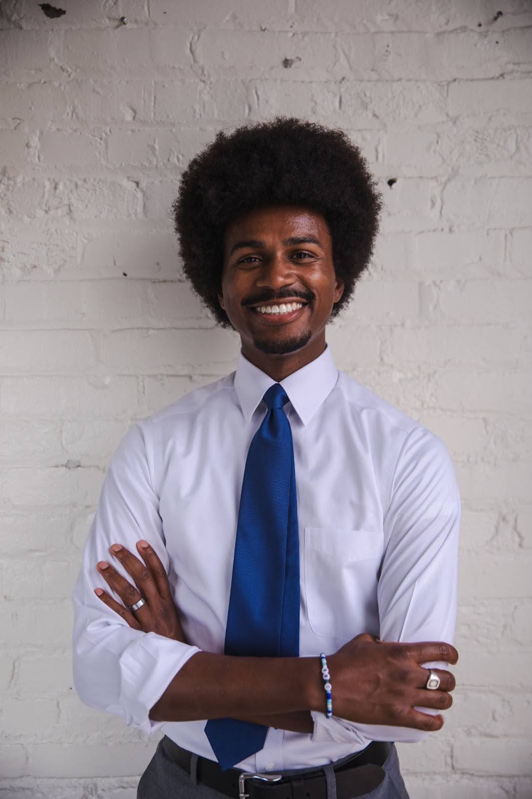A picutre of Justin J. Pearson in a white shirt with a blue tie.