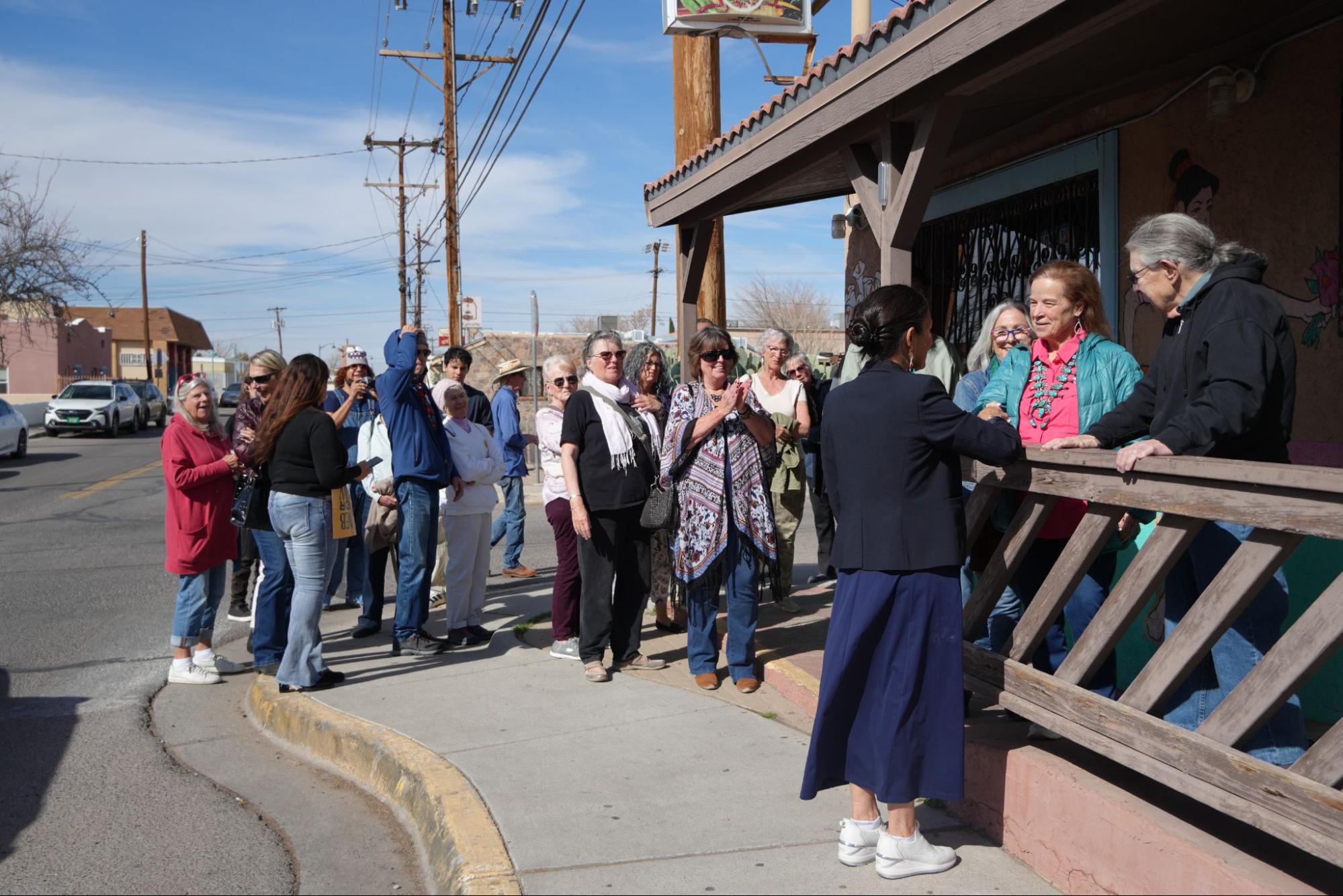 Image of Deb Haaland standing with supporters at an event.
