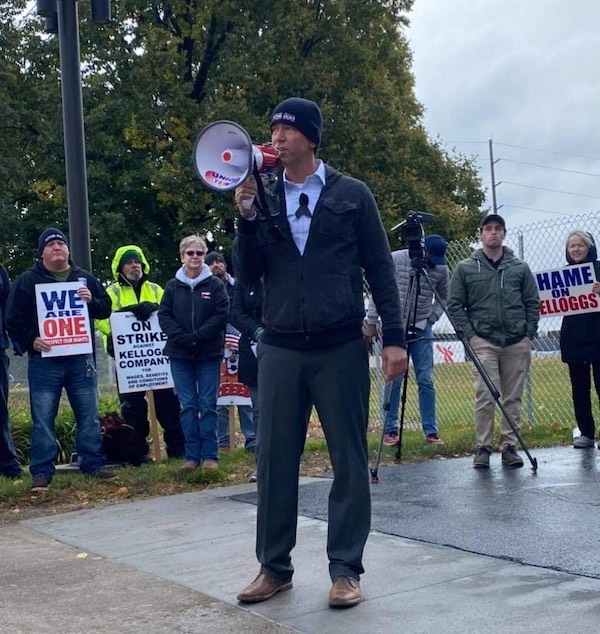 Photo of Dan Osborn on the picket line, speaking into a bullhorn