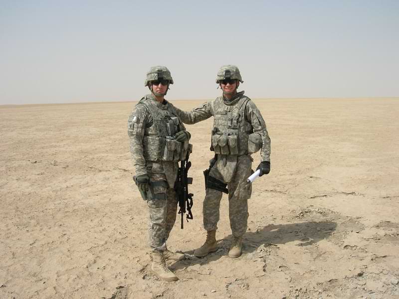 Congressman Deluzio in uniform standing with one of his fellow servicemen while deployed