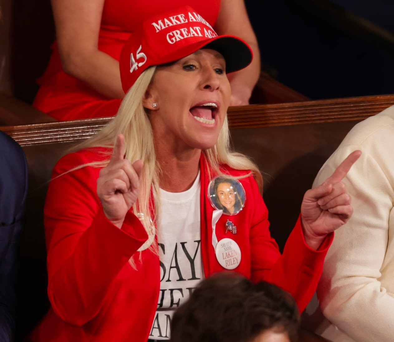 Marjorie Taylor Greene wears a MAGA hat while screaming at the State of the Union