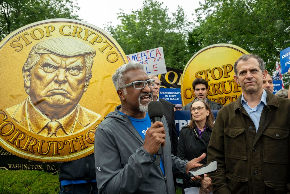 Picture of Our Revolution Executive Director Joseph Geevarghese speaking at a Crypto Corruption rally.