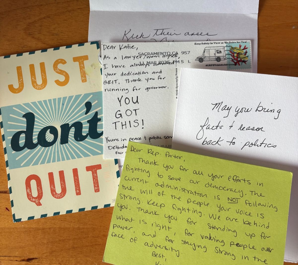 An image of 4 hand written notes to Katie Porter arranged on a table.