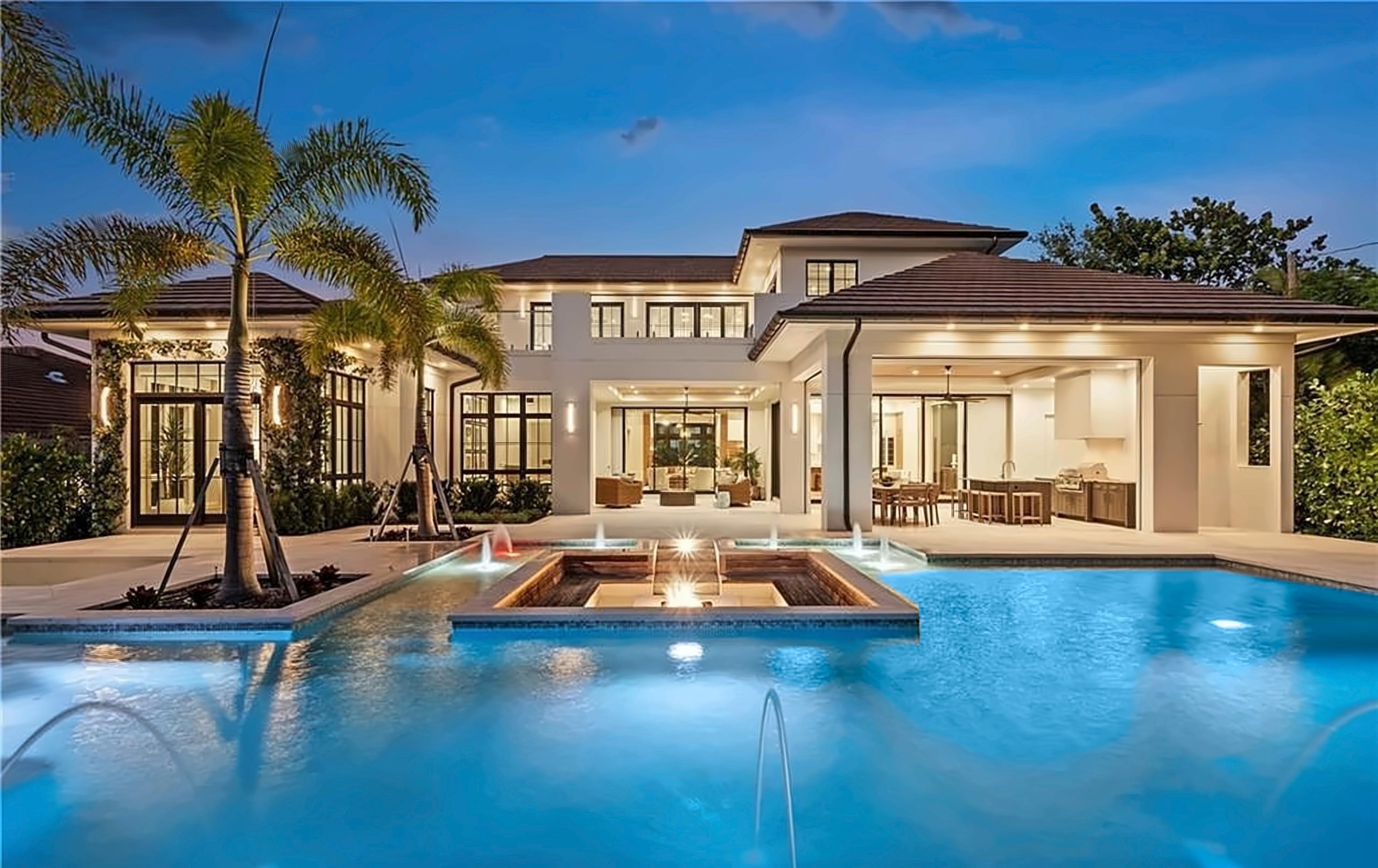 Luxury estate with a pool, lit at dusk