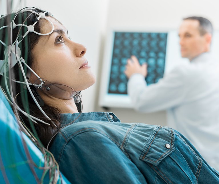 Neurological examination - Patient undergoing EEG procedure with neurologist's assistance