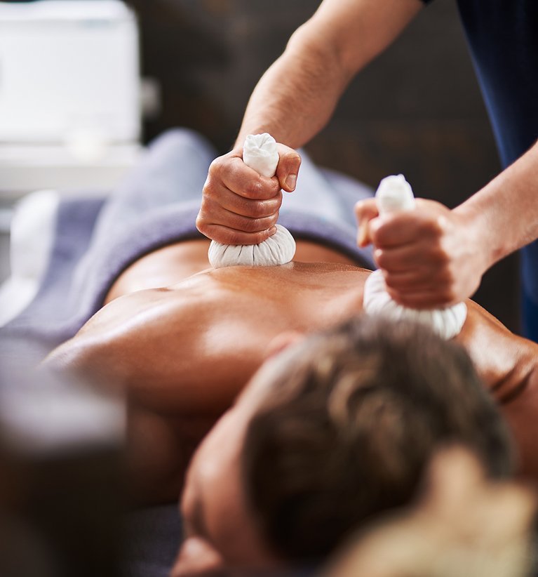 Patient receiving Ayurvedic massage from the therapist