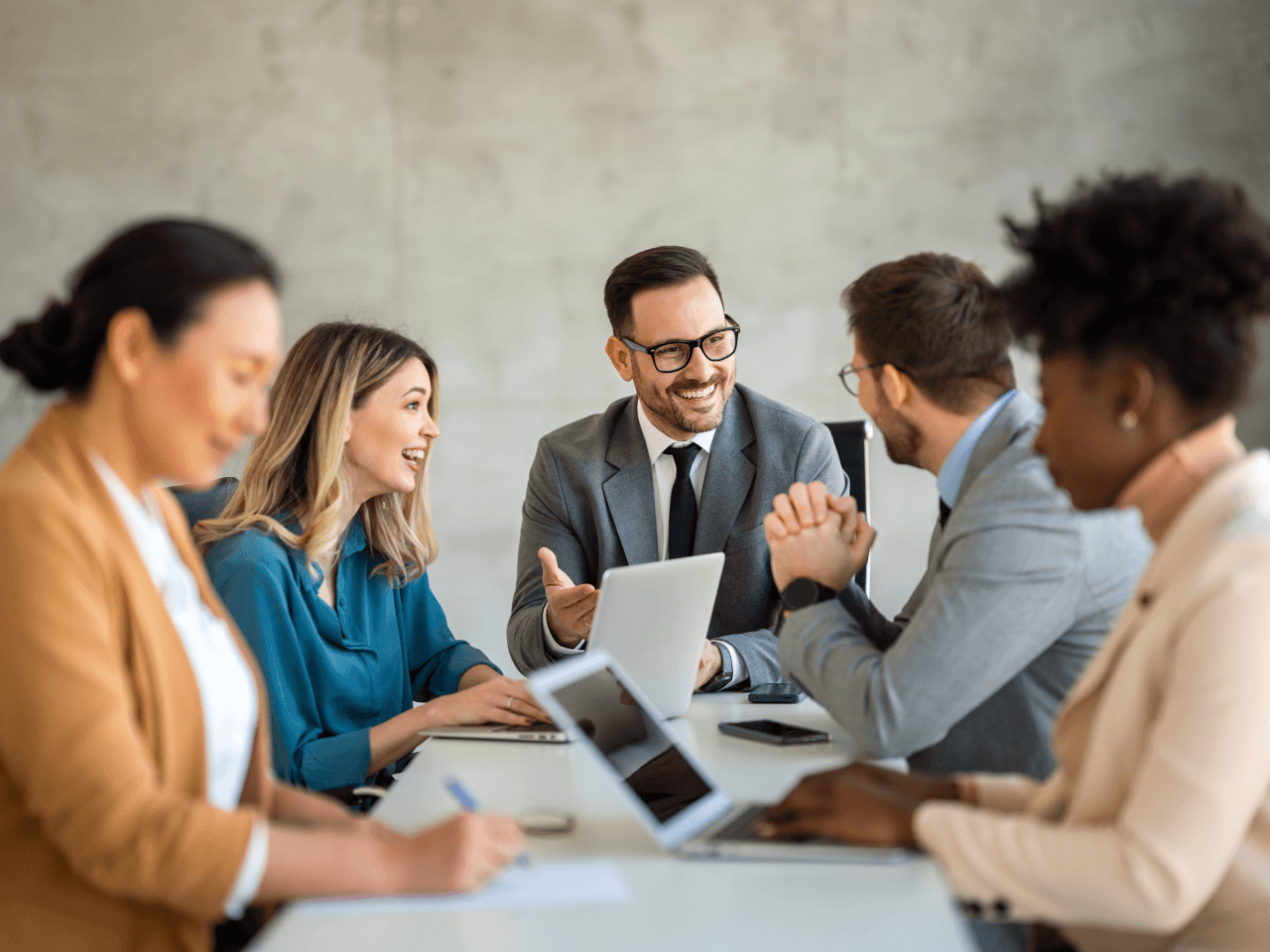 Group of young successful entrepreneurs discussing business agenda