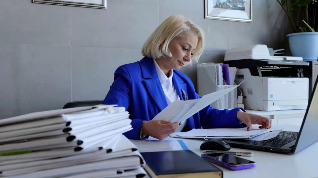 Women in office handling paperwork