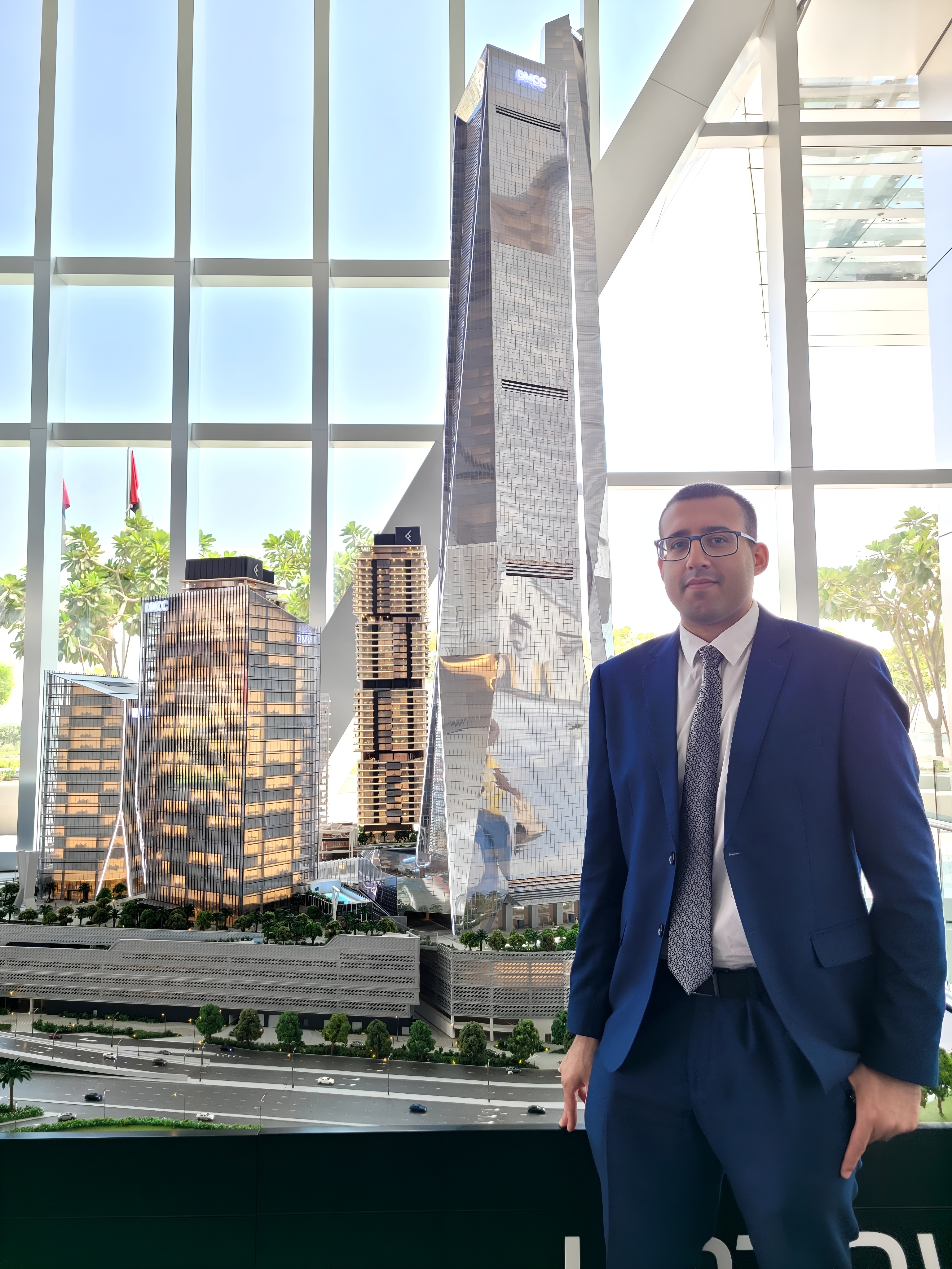 Inside the grand entrance hall of the New Uptown Tower, DMCC, I stand at the crossroads of ambition and opportunity.
