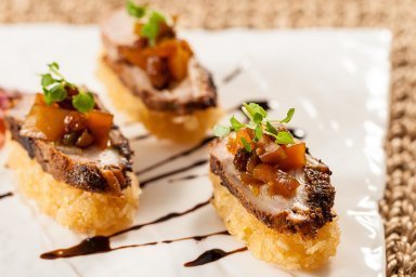 Roasted duck on crispy rice cake with spicy mango chutney