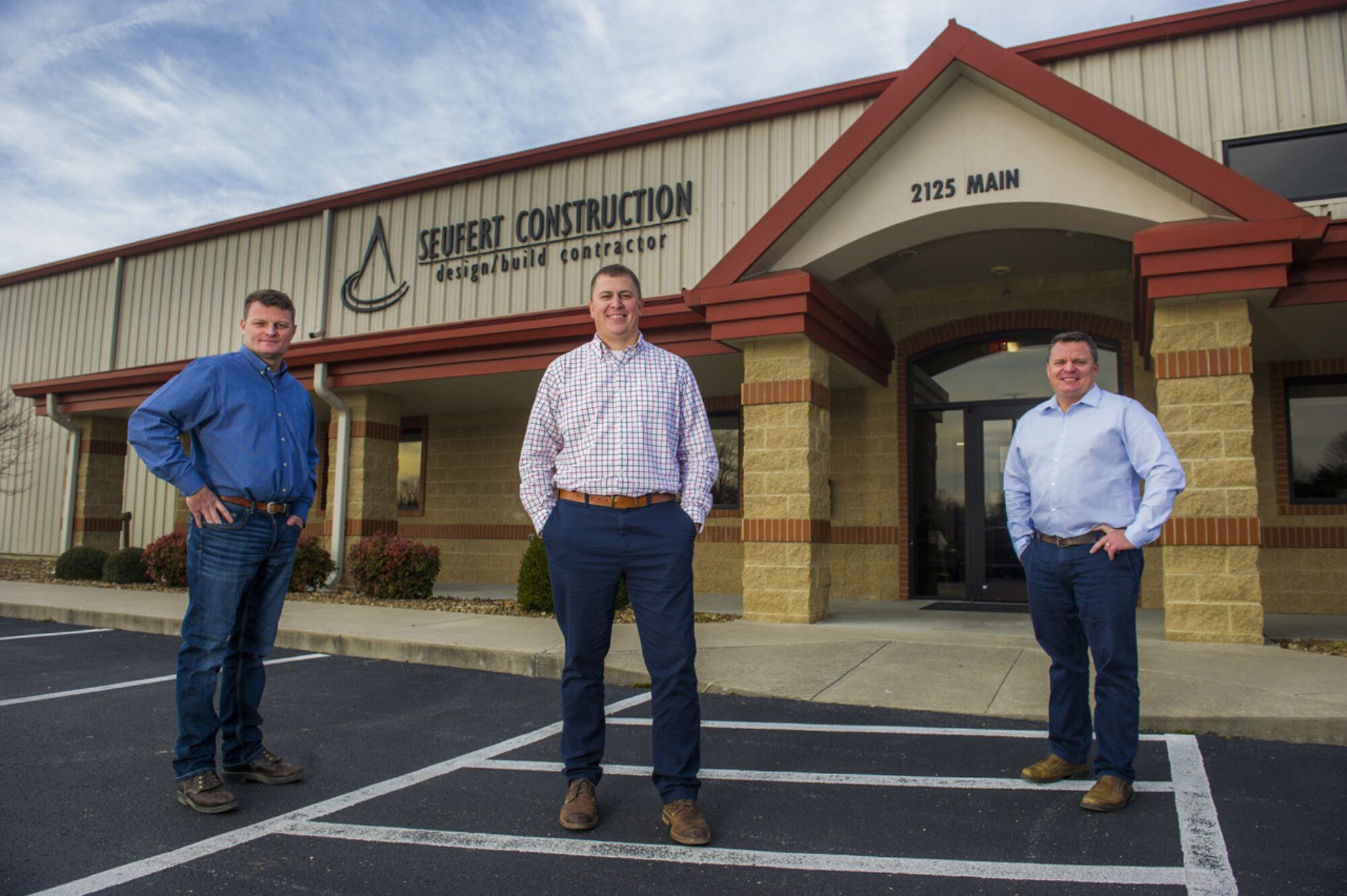 Seufert Construction owners standing outside of office building.