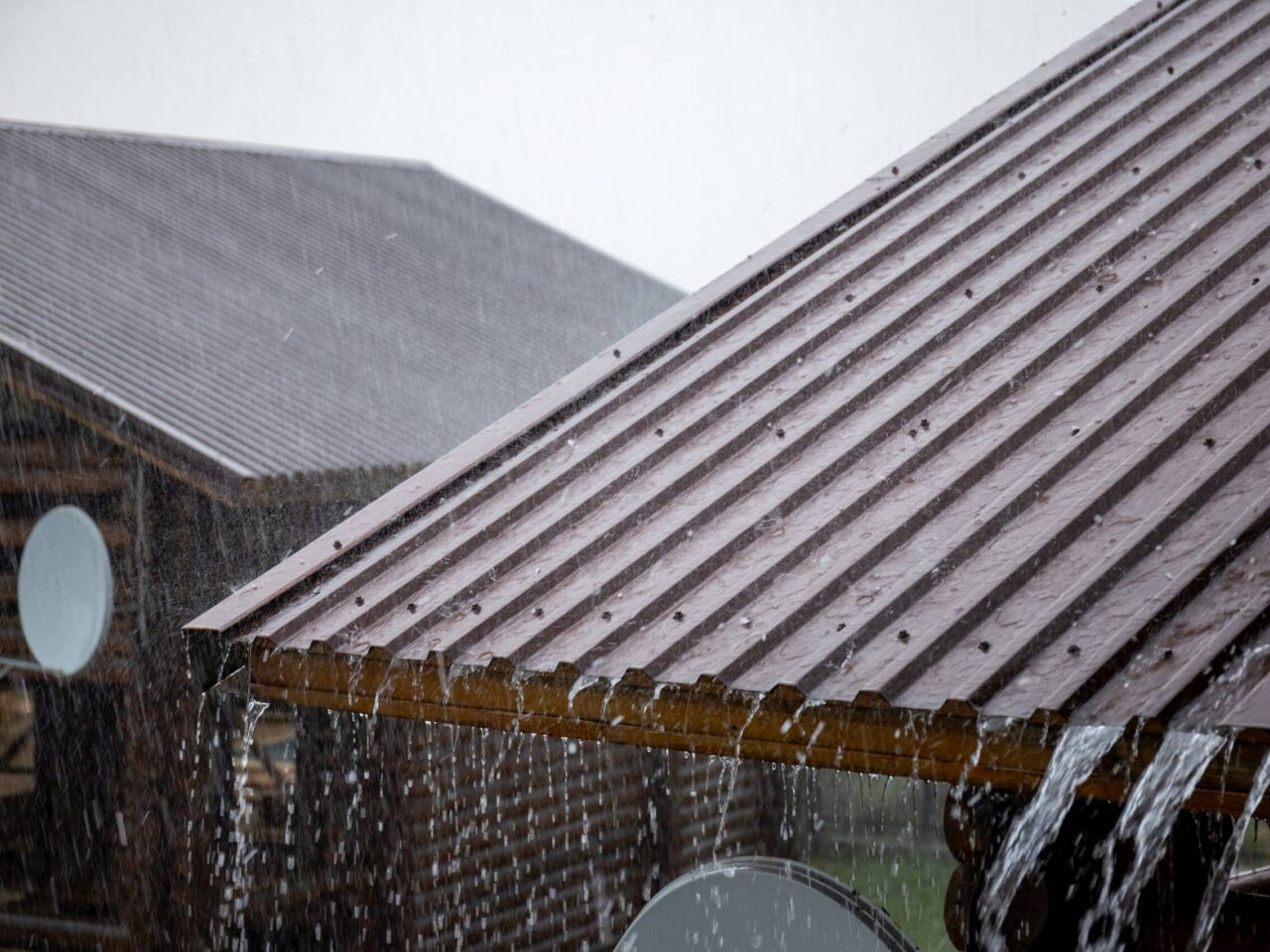 Standing seam metal roof shedding rain, showing weather resistance important for Midwest commercial buildings.