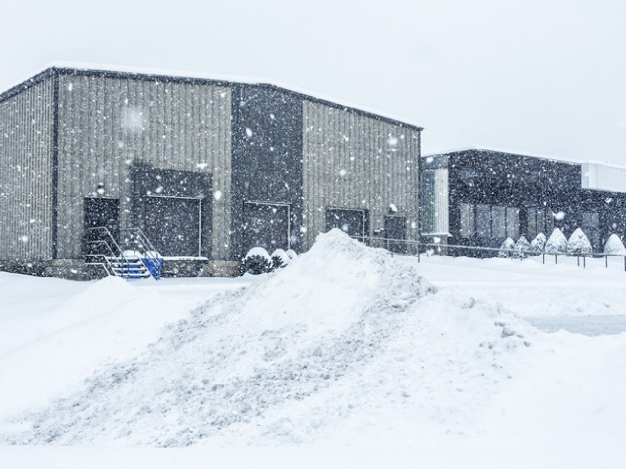 Southern Indiana commercial building with metal roof covered in snow during the wintertime.