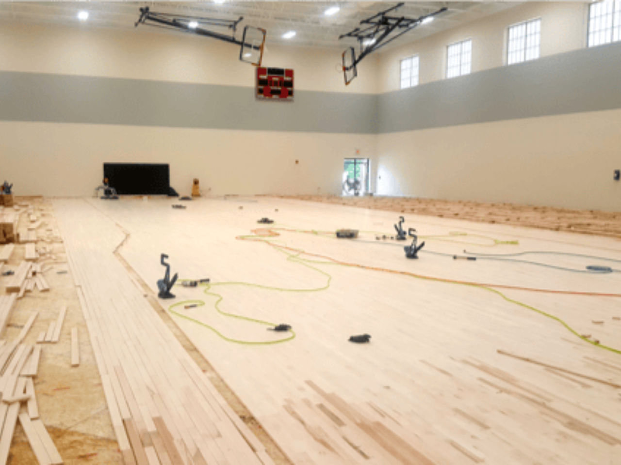Flooring system installation in a sports facility.