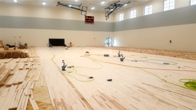 Flooring system installation in a sports facility.