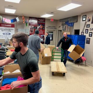 The ROP Shop Employees sorting clothing for Forgotten Children Worldwide.