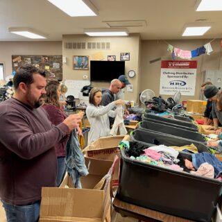 The ROP Shop Employees sorting clothing for Forgotten Children Worldwide.