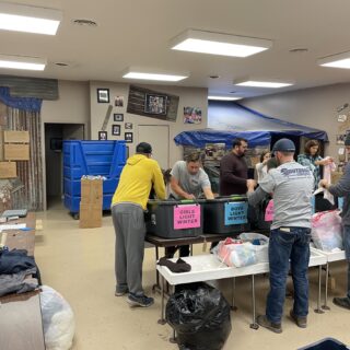 The ROP Shop Employees sorting clothing for Forgotten Children Worldwide.