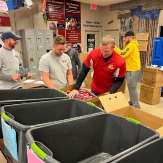 The ROP Shop Employees sorting clothing for Forgotten Children Worldwide.