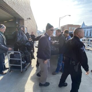 Officers helping unload gifts brought to hand out to inmates for Christmas Behind Bars through the volunteers at The ROP Shop and Outdoor Concepts.