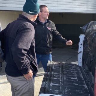 Officers helping unload gifts brought to hand out to inmates for Christmas Behind Bars through the volunteers at The ROP Shop and Outdoor Concepts.