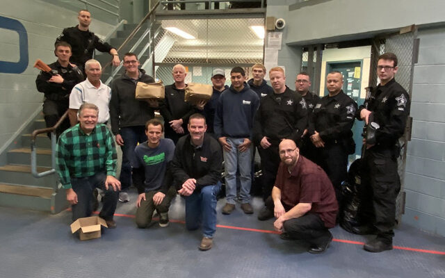 Officers pose with volunteers from The ROP Shop and Outdoor Concepts who participated in Christmas Behind Bars.