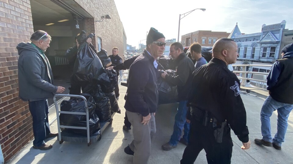 Officers helping unload gifts brought to hand out to inmates for Christmas Behind Bars through the volunteers at The ROP Shop and Outdoor Concepts.