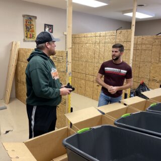 Employees of The ROP Shop and Outdoor Concepts sort and pack clothing to be shipped out by Forgotten Children Worldwide to needy around the world.
