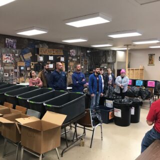 Employees of The ROP Shop and Outdoor Concepts sort and pack clothing to be shipped out by Forgotten Children Worldwide to needy around the world.