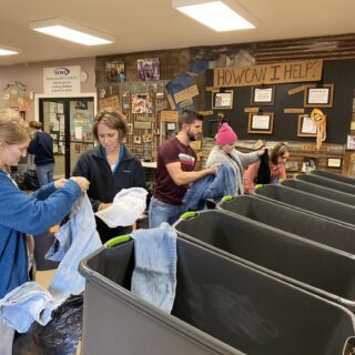 Employees of The ROP Shop and Outdoor Concepts sort and pack clothing to be shipped out by Forgotten Children Worldwide to needy around the world.