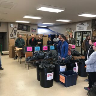 Employees of The ROP Shop and Outdoor Concepts sort and pack clothing to be shipped out by Forgotten Children Worldwide to needy around the world.