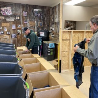Employees of The ROP Shop and Outdoor Concepts sort and pack clothing to be shipped out by Forgotten Children Worldwide to needy around the world.