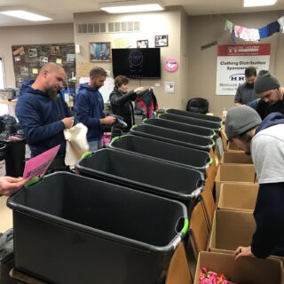 Employees of The ROP Shop and Outdoor Concepts sort and pack clothing to be shipped out by Forgotten Children Worldwide to needy around the world.