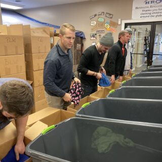 Employees of The ROP Shop and Outdoor Concepts sort and pack clothing to be shipped out by Forgotten Children Worldwide to needy around the world.