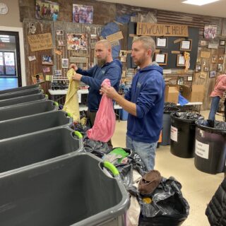 Employees of The ROP Shop and Outdoor Concepts sort and pack clothing to be shipped out by Forgotten Children Worldwide to needy around the world.