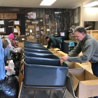 Employees of The ROP Shop and Outdoor Concepts sort and pack clothing to be shipped out by Forgotten Children Worldwide to needy around the world.