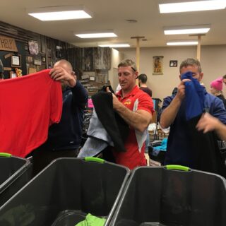 Employees of The ROP Shop and Outdoor Concepts sort and pack clothing to be shipped out by Forgotten Children Worldwide to needy around the world.