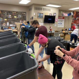 Employees of The ROP Shop and Outdoor Concepts sort and pack clothing to be shipped out by Forgotten Children Worldwide to needy around the world.