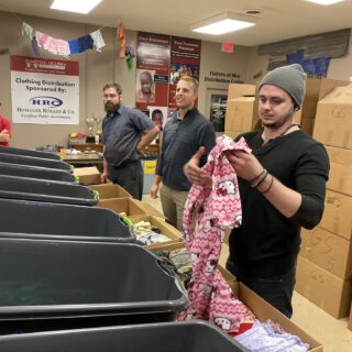 Employees of The ROP Shop and Outdoor Concepts sort and pack clothing to be shipped out by Forgotten Children Worldwide to needy around the world.