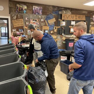 Employees of The ROP Shop and Outdoor Concepts sort and pack clothing to be shipped out by Forgotten Children Worldwide to needy around the world.