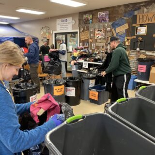 Employees of The ROP Shop and Outdoor Concepts sort and pack clothing to be shipped out by Forgotten Children Worldwide to needy around the world.